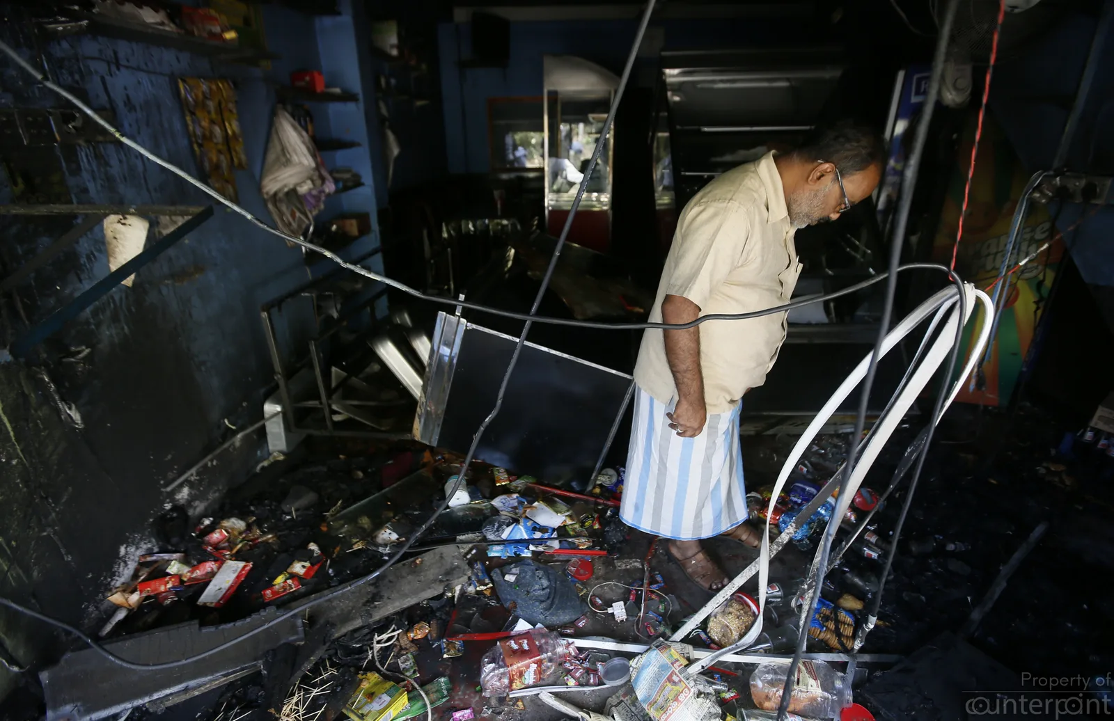 Inspecting the ruins of a shop in Digana on March 08.